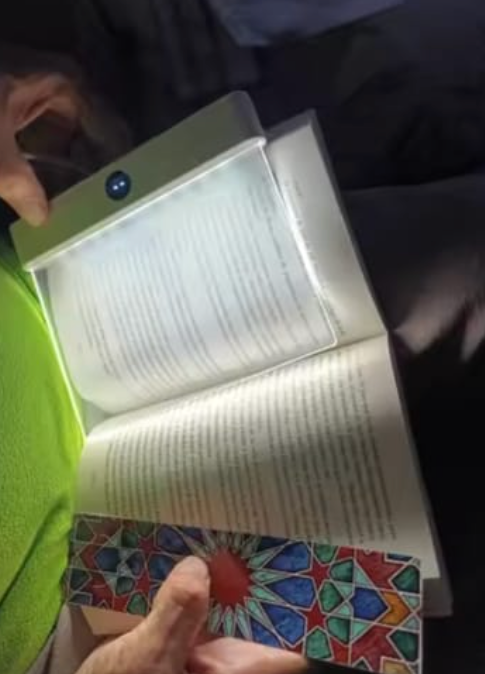 Reading screen illuminating a book in a dark room
