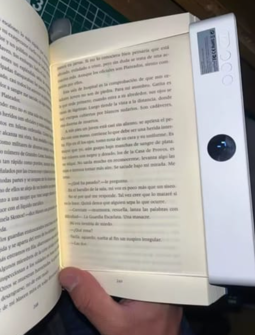 The Serene Light lying across the pages of a paperback.